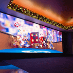 large LED screen showing red dice and casino chips flying into the air